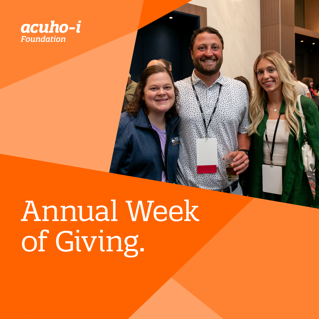 Three people smiling at an indoor event, all wearing name badges. Orange geometric shapes display the acUHO-i Foundation logo and the text Annual Week of Giving. Other attendees are in the background.